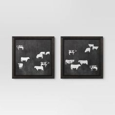 two black and white pictures with cows on them hanging on the wall next to each other