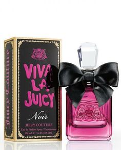 a bottle of juicy couture perfume with a bow on the front and box behind it