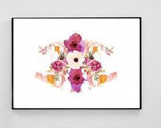 a cross stitch pattern with pink and white flowers on a white background, framed in black frame