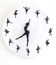 a clock with black silhouettes of ballet dancers on it's face and hands