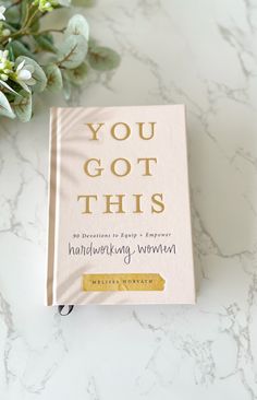 a book sitting on top of a table next to flowers