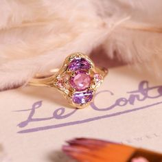 a pink ring sitting on top of a piece of paper