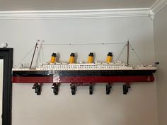 a model ship is hanging on the wall