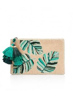 a green and white clutch bag with palm leaves on it