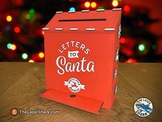 a red letter to santa box sitting on top of a wooden table