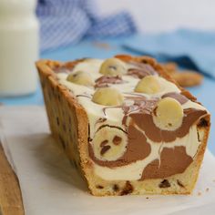 a person touching the top of a cake in a pan with icing on it