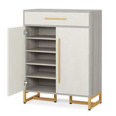 a white and grey cabinet with gold handles on the bottom, two shelves below it