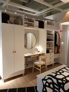 a bedroom with a bed, desk and closet