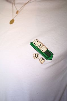 An original way to present yourself with this Scrabble t-shirt! To simply say hello or to write whatever you want, it's possible to customize it: for 5€ more, have the 5 letters of your choice embroidered and for 10€ more, you can add a letter! Machine embroidery on the chest, embroidered by me. Unisex tee. XS to 5XL. If you don't see your size, don't hesitate to ask me, maybe i have it in my stock! Tshirts are OEKO-TEK certified, meaning that the production contains no substance harmful to people or to the environment and take part in the FAIR WEAR FOUNDATION. See The Way I See, Tshirt With Embroidery, Ideas For Tshirt Design, Mens Embroidery Designs, Back In Stock Graphic, T Shirt Packaging Ideas, Embroidered Merch, T Shirt Embroidery Ideas, Embroidered Typography