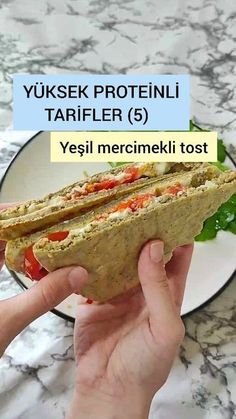 a person holding a sandwich in their hand with the words yukse proteini tarifer 5