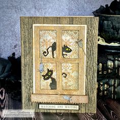 a wooden frame with cats on it next to some books