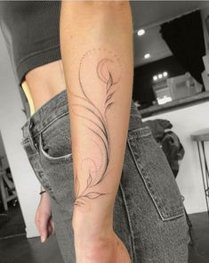 a woman's arm with a tattoo on it and a flower in the middle