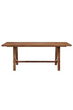 a wooden table sitting on top of a white wall