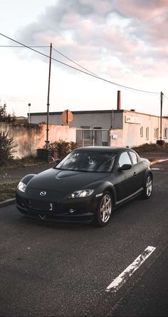 a black sports car is parked on the street