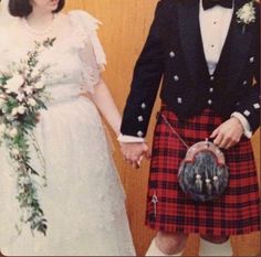 a man and woman in kilts holding hands