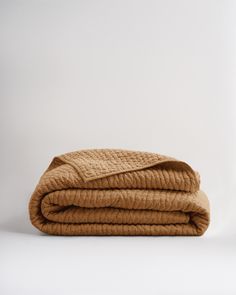 the blanket is folded up on top of each other, and it's brown