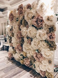 an artificial flower wall in the lobby of a hotel with white and pink flowers on it