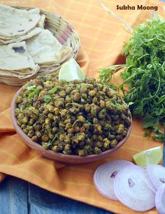 some food that is in a bowl and on a table next to other foods such as tortillas