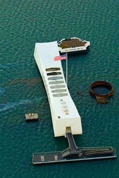 a large white building floating on top of the ocean