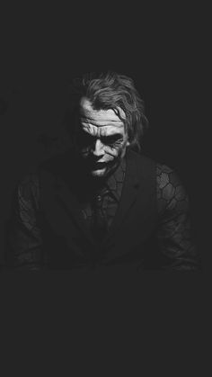 the joker in black and white with his face painted like he is looking at something