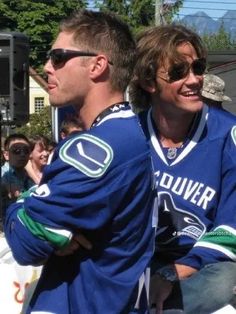 two men in blue jerseys sitting next to each other