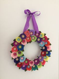 a paper flower wreath hanging on the wall