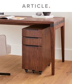 a wooden desk with two drawers underneath it and the words article above it that reads,