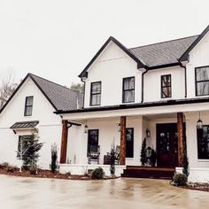 a large white house with black trim and windows