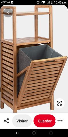 a wooden shelf with a bin on the bottom and a grey fabric bag in it