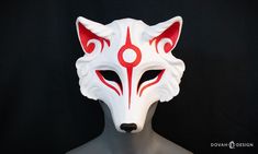 Embody the spirit of Amaterasu with this handmade resin Okami mask! Perfect for Halloween, Masquerade parties, Anime conventions, and other fanciful festivities. ** Mask is HANDMADE TO ORDER in 2-3 weeks **  Wolf masks are cast from an original Dovah Design sculpt, making them a truly unique mask you will find nowhere else. This "Okami style" mask is cast using an opaque white resin backed with super black resin on the inside. Cast is from original sculpture mold, and will have a slightly textured surface. Each mask is hand painted with red and black facial details in a Japanese-themed style. Masks are top coated with clear Matte enamel to help preserve painted details.  Mask comes with your choice of black "aida cloth" mesh behind the eyes to obscure the wearer's eyes, or with no mesh so Wolf Mask Anime, Okami Mask, Wolf Masks, Unique Masks, Wolf Mask, Japanese Mask, Anime Conventions, Aida Cloth, Halloween Masquerade