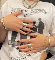 a woman wearing multiple rings on her fingers