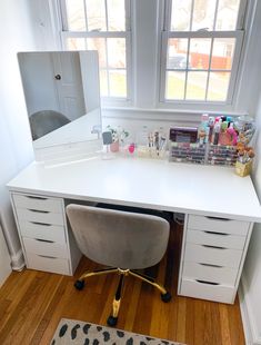 a white desk with drawers and a mirror