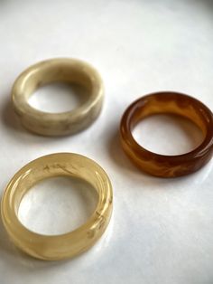 three different types of rings on a white surface