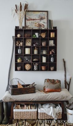 a shelf filled with lots of items next to a wall mounted on the side of a wall