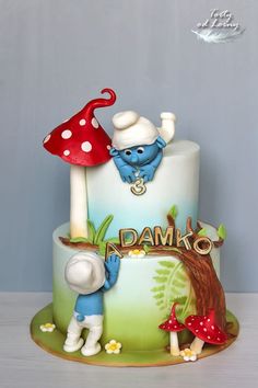 there is a birthday cake with an image of the smurfs on it and mushrooms