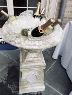 a fountain with bottles of wine in it