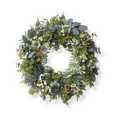 a wreath with white flowers and green leaves