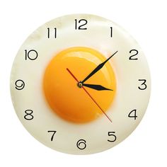 a clock with an egg in the middle of it's face on a white background