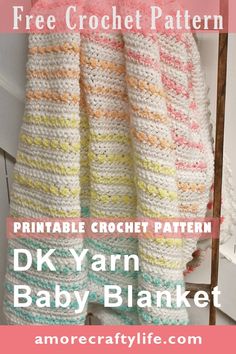 a crocheted baby blanket hanging from a hook with text overlay that reads free crochet pattern printable crochet pattern dk yarn baby blanket