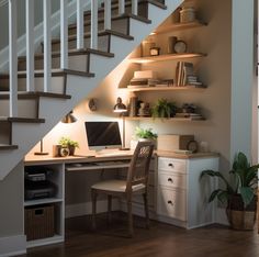 a home office under the stairs in a house