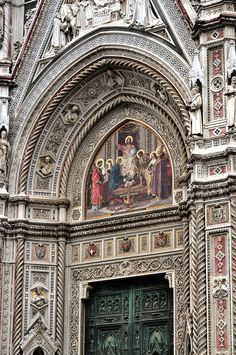 an ornate doorway with paintings on it