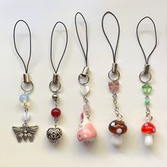 six different necklaces with charms attached to them