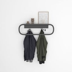 two umbrellas are hanging on the wall next to an open coat rack with hooks