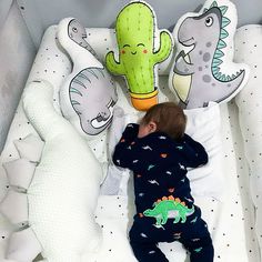 a baby sleeping in a crib with stuffed animals