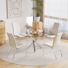 a glass table with four chairs around it