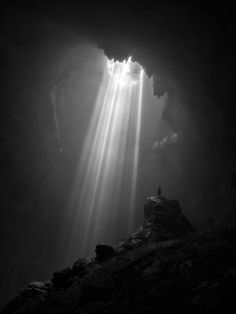 the light is shining through the clouds in this cave