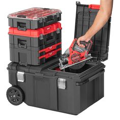 a man is holding a tool box with tools in it