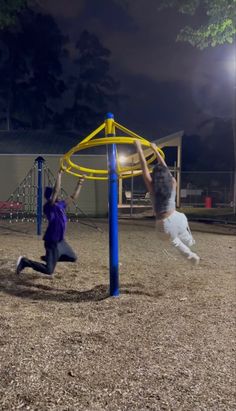 two children playing with a yellow and blue pole