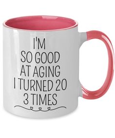 a pink and white coffee mug with the words i'm so good at aging it turned