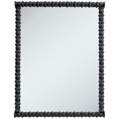 a black framed mirror sitting on top of a white wall